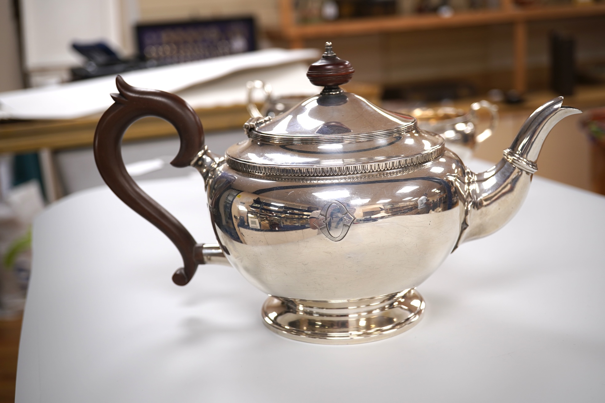 A George V silver circular three piece tea set, with engraved initial, Fenton, Russell & Co Ltd, London, 1927, gross weight 32.4oz.